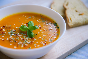 Closeup photo of seasonal autumn pumpkin soup and homemade pumpkin bread