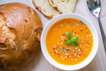 Closeup photo of seasonal autumn pumpkin soup and homemade pumpkin bread