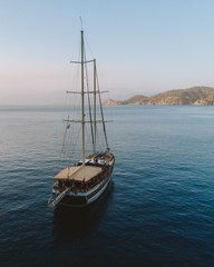 Traditional Turkish Gulets along the mountainous mediterranean coastline at sunset. The luxury...