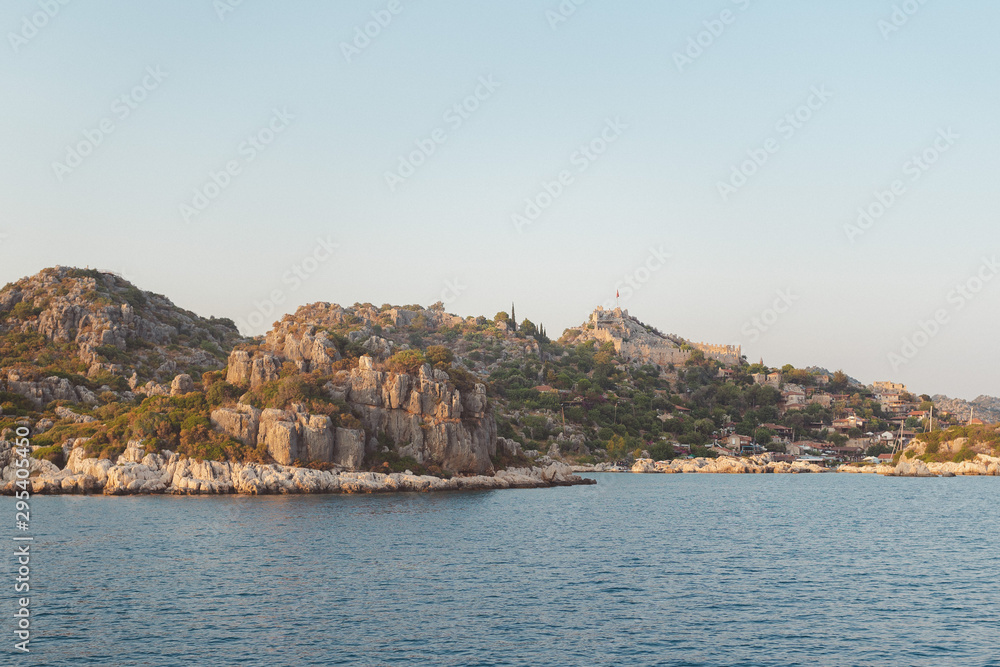 Wall mural the village of kalekoy seen south from a drone aerial perspective, with the byzantine simena castle 