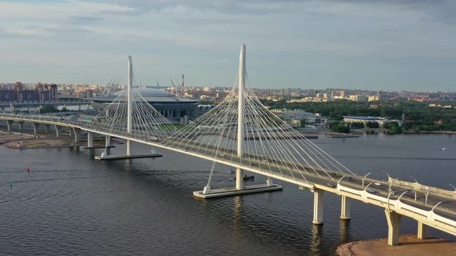 Aerial around view of cable-stayed bridge and new stadium in St.Petersburg during sunset, 4k