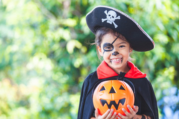 Cute asian child girl wearing halloween costumes and makeup having fun on Halloween celebration