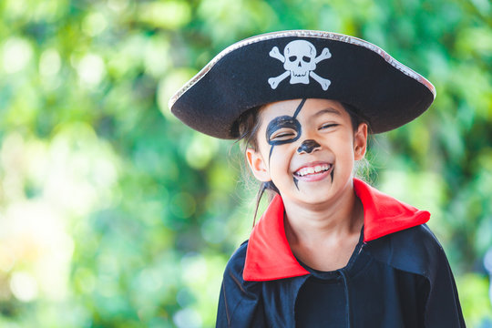 Cute asian child girl wearing halloween costumes and makeup having fun on Halloween celebration