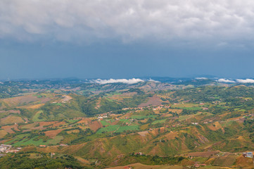 Fototapeta premium Aerial view of Italian countryside with farm fields and hills