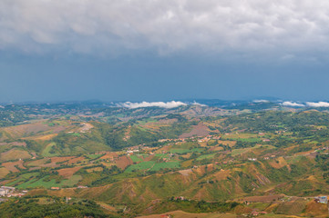 Aerial view of Italian countryside with farm fields and hills