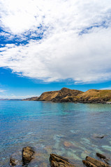 Fototapeta na wymiar Seascape with mountain coastline and crystal clear water