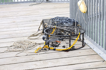 Crab traps with rope lay on a deck