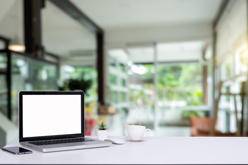 Fototapeta na wymiar Desk Laptop with blank screen on table blur background with bokeh background