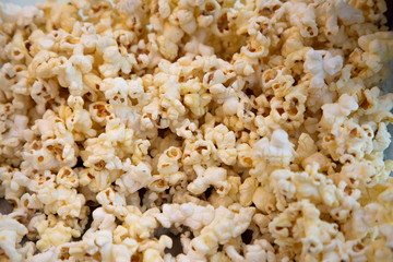 popcorn buttery and salty unhealthy snack textured .