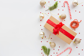 Christmas composition. Wrapped gift, wooden toys lying on white background. new year concept. Greeting card, winter holidays, xmas celebration 2020. Flat lay, top view, copy space, mockup, template