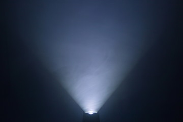 flashlight and light beam in dark mist room at night . abstract projector spotlight white lay...