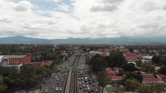 Aerial view of the traffic in Calzada de Tlalpan, Mexico City. Drone flying forward