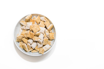 A bowl of whole grain cereal in a bowl on a white background.