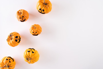 Top view of Halloween crafts, orange pumpkin, ghost on white background with copy space for text. halloween concept.