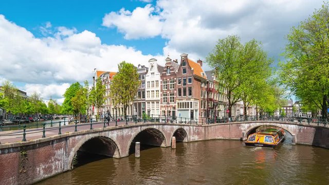 Dutch old buildings and canal in Amsterdam city, Netherlands time lapse.