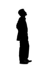 Full body silhouette of a businessman isolated on a white background. He is standing and waiting and posed as if bored or impatient.