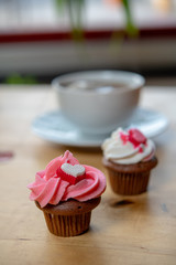 pink and white muffins with heart and coffee cup