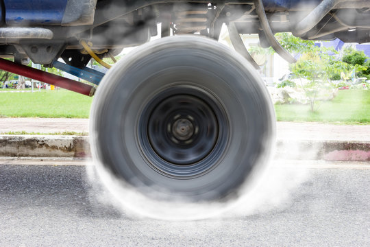 Off-road Car Spinning Wheel Burns Rubber On Floor