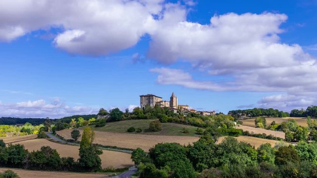 timelapse of the french village of Lavardens in the Gers with blue sky and white clouds