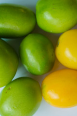 Background from green tomatoes with yellow in the center. Culinary background with blank space for text. copy space, top view, flat lay