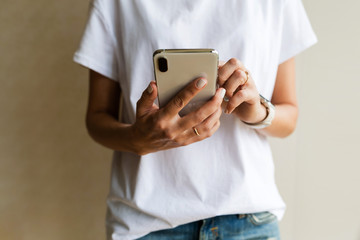 Hands using a phone texting on smartphone app, searching or social networks concept, hipster woman...
