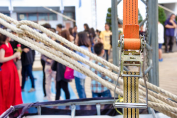 ratchet strap with blurry people background
