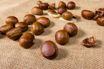 fresh chestnuts with sack bag background.