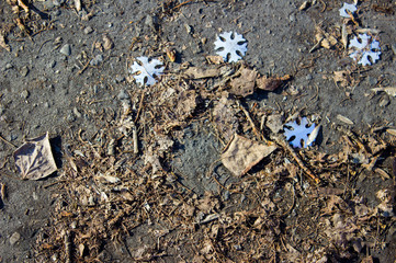 Silver foil snowflakes on the ground.top view, flat lay, background with blank space for text