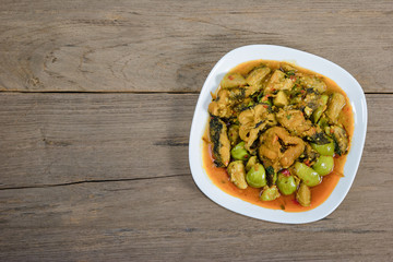 Spicy Fried Stir Catfish on wood background