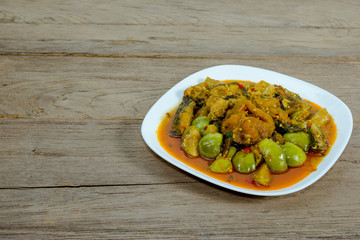 Spicy Fried Stir Catfish on wood background