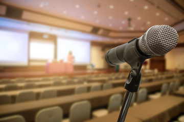 Microphone over the blurred forum Meeting Conference Training Learning Coaching room Concept, Blurred background.