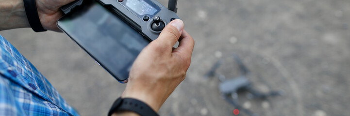 Modern with hand remote copter on gray background for concept design. Innovation technology concept device.