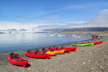 Fototapeta premium Kayaks on the shore of Jokulsarlon glacier lagoon, south Iceland, Europe. Selective focus