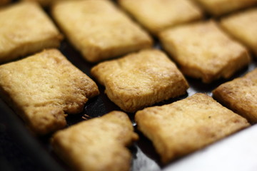 Freshly baked cookies in baking tray
