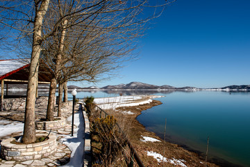 Fototapeta na wymiar Snowy landscapes. Lake Plastira on Winter. Greece