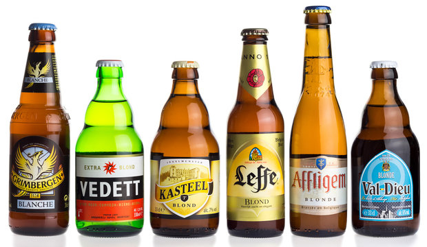 GRONINGEN, NETHERLANDS - APRIL 16, 2017: Collection of Grimbergen, Vedett, KAsteel, Leffe, Affligem, Val-Dieu blond beers isolated on a white background