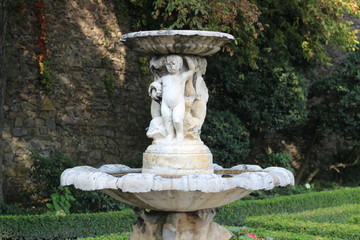 Ancient fountain in the castle. Fountain with angels.