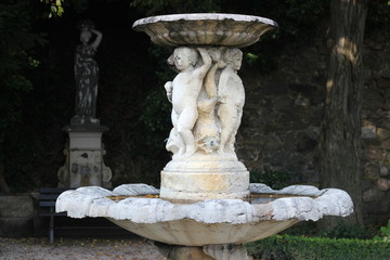 Ancient fountain in the castle. Fountain with angels.