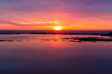 Fototapeta na wymiar Coastal sunrises as daybreaks turning skies red, orange, pink and yellow
