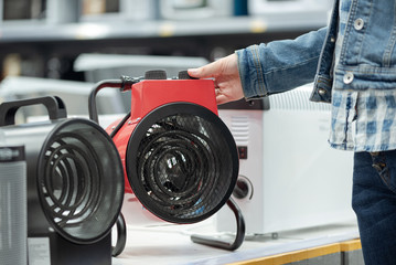 Woman is choosing a new heater for home.