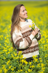Happy young woman in autumn or spring field
