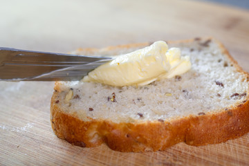 Spreading butter on bread with table knife