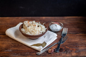 Plate with sour cabbage. This is a useful fermented product. Sour cabbage is rich in vitamins and is used in many dishes of different nations. The fermentation process does not destroy nutrients. 