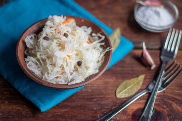 Plate with sour cabbage. This is a useful fermented product. Sour cabbage is rich in vitamins and is used in many dishes of different nations. The fermentation process does not destroy nutrients. 