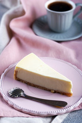 Cheesecake and black coffee and a small cup