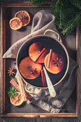 Strong mulled red wine with cinnamon and oranges