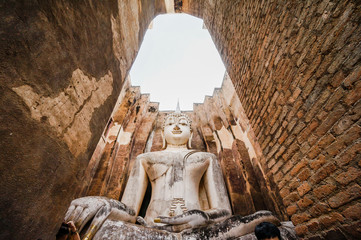 Ruins temple Sukothai historical park, Unesco world heritage, Thailand, the body to head part of the big buddha image at Wat Sri Chum in Sukhothai.