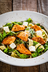 Pasta with chicken meat, feta cheese and rucola