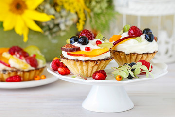 Colorful cupcakes with fresh fruits.