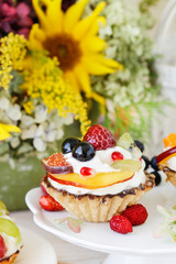 Colorful cupcakes with fresh fruits.